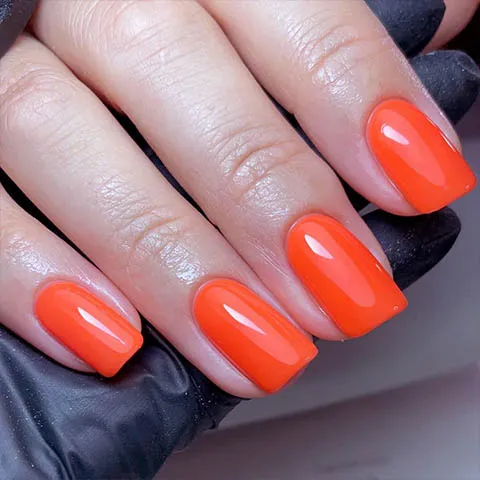 Square gel nails in bright orange