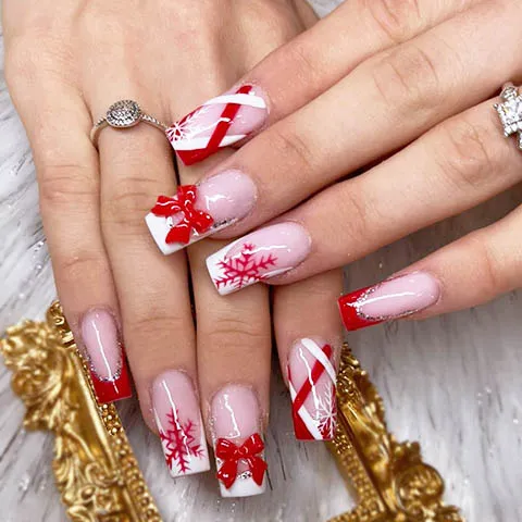 Christmas nail design with candy canes, bows and snowflakes