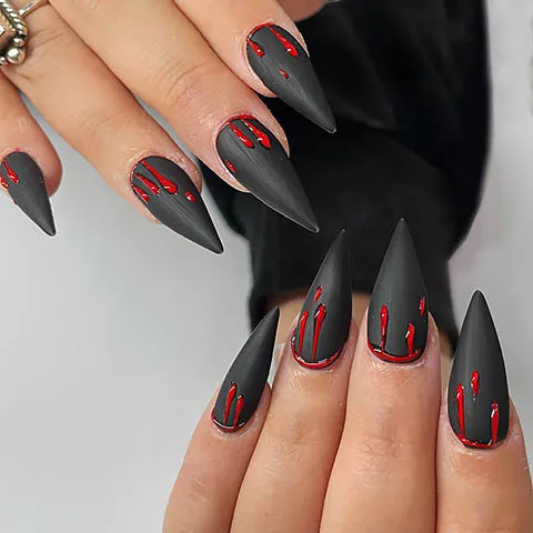 Matte black stiletto nails with red drips
